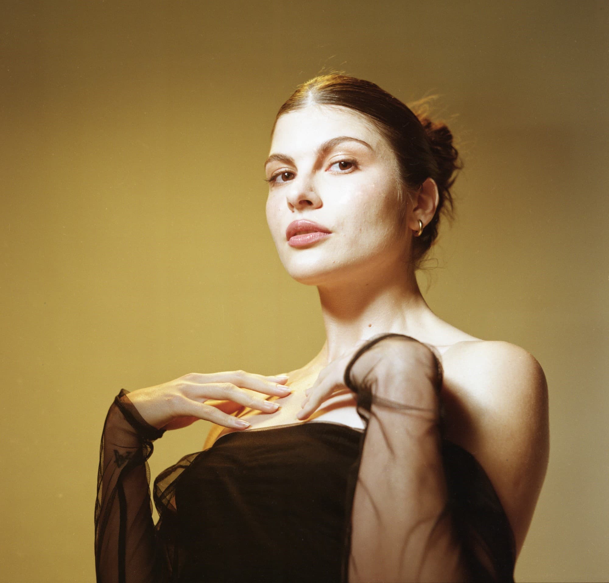 Glamour studio portrait with natural makeup of young woman on Kodak Gold 200 medium format color film.