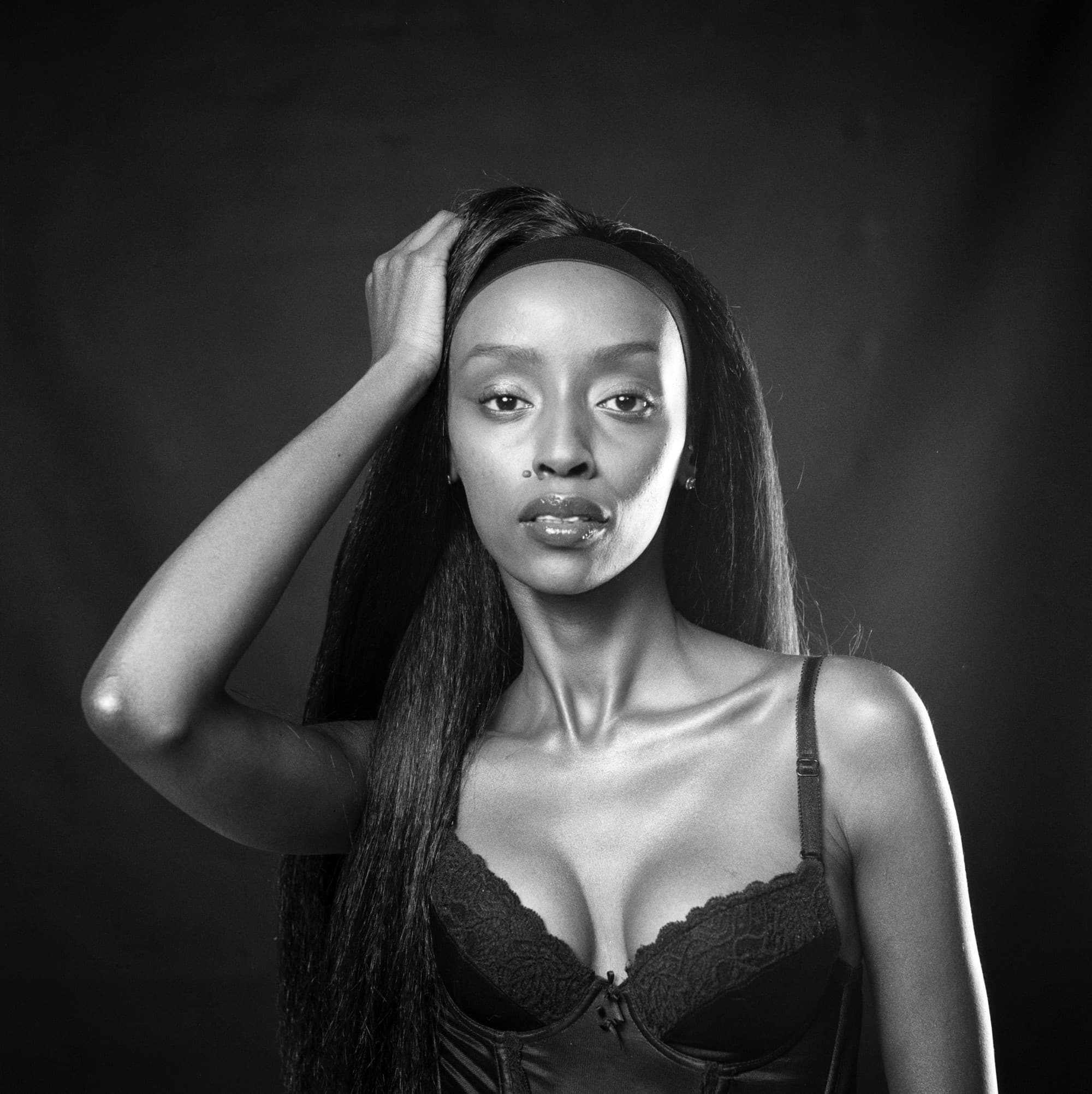 Black and white studio portrait of dark skin beautiful woman on Kentmere 400 medium format film.